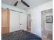 Spacious bedroom with barn door, ceiling fan, and an open doorway to the bathroom at 9575 Ne 306Th Ct, Fort Mc Coy, FL 32134