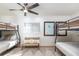 Bright bedroom with bunk beds, comfortable bedding, and natural light from the window at 9575 Ne 306Th Ct, Fort Mc Coy, FL 32134