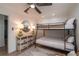 Cozy bedroom with a bunk bed, dresser, and a stylish rug on the wood floor at 9575 Ne 306Th Ct, Fort Mc Coy, FL 32134
