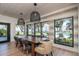 Dining room featuring a long wood table and scenic views of the pool at 9575 Ne 306Th Ct, Fort Mc Coy, FL 32134