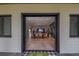 Inviting entryway view of dining and living areas featuring wood floors and lots of natural light at 9575 Ne 306Th Ct, Fort Mc Coy, FL 32134