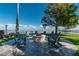 Serene backyard with a stone fire pit and comfortable seating overlooking the water at 9575 Ne 306Th Ct, Fort Mc Coy, FL 32134