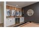 Beautifully decorated game room featuring a custom wet bar with wine fridge and wood accents at 9575 Ne 306Th Ct, Fort Mc Coy, FL 32134