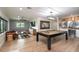 Spacious game room featuring a pool table, leather sofa, wet bar, and custom decor at 9575 Ne 306Th Ct, Fort Mc Coy, FL 32134