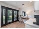 Bright home office with outside patio view, custom desk, and beverage area at 9575 Ne 306Th Ct, Fort Mc Coy, FL 32134