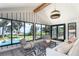 Bright living room with water view, vaulted ceiling, modern lighting, and comfortable seating with a neutral palette at 9575 Ne 306Th Ct, Fort Mc Coy, FL 32134