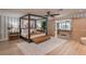 Comfortable bedroom with king bed, wooden floors, ceiling fan, and a view at 9575 Ne 306Th Ct, Fort Mc Coy, FL 32134