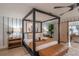 Comfortable bedroom with king bed, wooden floors and a view at 9575 Ne 306Th Ct, Fort Mc Coy, FL 32134