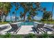 Backyard featuring a swimming pool and hot tub with poolside lounge chairs at 9575 Ne 306Th Ct, Fort Mc Coy, FL 32134