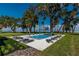 Stunning pool with lounge chairs surrounded by lush greenery and mature trees at 9575 Ne 306Th Ct, Fort Mc Coy, FL 32134
