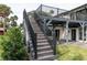Backyard stairs leading up to the deck with a view of the patio and yard at 9575 Ne 306Th Ct, Fort Mc Coy, FL 32134
