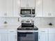 Modern kitchen with stainless steel appliances, bright lighting and white subway tile back splash at 993 Calico Pointe Cir, Groveland, FL 34736