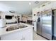 Bright kitchen island and stainless steel fridge, with open view to living and dining areas at 993 Calico Pointe Cir, Groveland, FL 34736