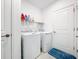 Laundry room featuring a washer and dryer with a shelf above and a blue rug on the floor at 993 Calico Pointe Cir, Groveland, FL 34736