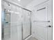 A glass shower with a sliding door and silver hardware in a modern style at 993 Calico Pointe Cir, Groveland, FL 34736