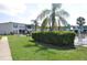 Manicured backyard, community pool, sidewalk and lawn at 1006 Plantation Dr # F11, Kissimmee, FL 34741