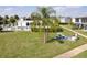 Exterior view of a community lawn with picnic table and grilling station near the community pool at 1006 Plantation Dr # F11, Kissimmee, FL 34741