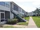 Exterior shot showcasing building with stairway access, grassy area, and sidewalk at 1006 Plantation Dr # F11, Kissimmee, FL 34741