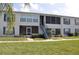 Exterior of condo building featuring stairs to units, screened patios, and well-maintained landscaping at 1006 Plantation Dr # F11, Kissimmee, FL 34741