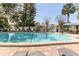 Pool area with pool and chairs at 1100 Delaney Ave # F204, Orlando, FL 32806