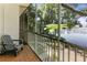 Tranquil screened porch with a comfortable chair and stunning views of the lake and surrounding greenery at 1100 Delaney Ave # F204, Orlando, FL 32806