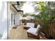 Back porch with outdoor furniture, potted palm trees and white brick wall at 12 S Lawsona Blvd, Orlando, FL 32801