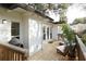 Exterior porch featuring a grill, seating, potted plants and white painted brick at 12 S Lawsona Blvd, Orlando, FL 32801