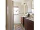 Modern bathroom featuring dual vanities with wooden cabinets, mirrors, and a walk-in shower at 12 S Lawsona Blvd, Orlando, FL 32801