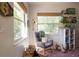 Bright Bedroom featuring a rocking chair, window, and bookshelves filled with books and decorations at 12 S Lawsona Blvd, Orlando, FL 32801