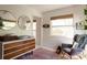 Serene Bedroom featuring a changing table, rocking chair, and bright natural light from a large window at 12 S Lawsona Blvd, Orlando, FL 32801