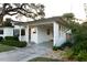 The carport provides cover in front of a home with well-manicured landscaping and driveway at 12 S Lawsona Blvd, Orlando, FL 32801