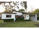 Exterior elevation shows modern white home, manicured hedges, and lots of shade at 12 S Lawsona Blvd, Orlando, FL 32801