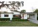 Charming single-story home with covered carport, well-manicured lawn, and mature landscaping at 12 S Lawsona Blvd, Orlando, FL 32801