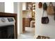 View into a contemporary styled kitchen from hallway with laundry area at 12 S Lawsona Blvd, Orlando, FL 32801