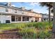 Townhome back exterior featuring outdoor living and grassy space with well-maintained landscaping at 1218 Falling Star Ln, Orlando, FL 32828