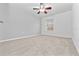 Bright bedroom with neutral carpet, ceiling fan, and single window at 1218 Falling Star Ln, Orlando, FL 32828