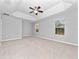 Spacious bedroom featuring tray ceilings, neutral carpet, and great natural light at 1218 Falling Star Ln, Orlando, FL 32828