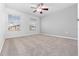 Spacious bedroom with neutral carpet, ceiling fan, and bright windows at 1218 Falling Star Ln, Orlando, FL 32828