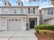 Close up shot of a well-maintained townhome with a two-car garage at 1218 Falling Star Ln, Orlando, FL 32828