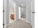 Hallway with carpet, archway and multiple doorways including view of cherry vanity bathroom at 1218 Falling Star Ln, Orlando, FL 32828