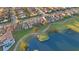 Aerial view of homes on a golf course with a nearby lake at 13231 Woodford St, Orlando, FL 32832