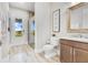 Elegant bathroom featuring a classic toilet, wooden cabinets, and a decorative mirror at 13231 Woodford St, Orlando, FL 32832