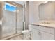 Modern bathroom with a glass enclosed shower and a single sink vanity with cabinet storage at 13231 Woodford St, Orlando, FL 32832