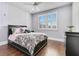 Comfortable bedroom with ceiling fan features hardwood floors, a window and a large bed at 13231 Woodford St, Orlando, FL 32832