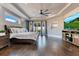 Inviting bedroom featuring a king-size bed, a large ceiling fan, and sliding glass doors at 13231 Woodford St, Orlando, FL 32832