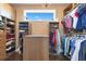 Well-organized walk-in closet with custom shelving, hanging rods, and ample storage space at 13231 Woodford St, Orlando, FL 32832