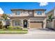 Charming two-story home with lush landscaping and a tile roof at 13231 Woodford St, Orlando, FL 32832