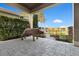 Charming outdoor patio area with a decorative pig, lush foliage, and a cozy fire pit at 13231 Woodford St, Orlando, FL 32832