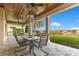 Inviting outdoor patio with a ceiling fan, table, chairs, and views of lush green backyard at 13231 Woodford St, Orlando, FL 32832