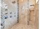 Luxurious shower with multiple shower heads, stylish tiling, and built-in storage niches at 13231 Woodford St, Orlando, FL 32832